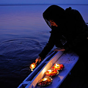 Diyas or votive lights in the river Ganges, Varanasi, India
